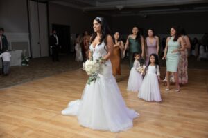 A bride holding her bouquet inside Ocoee Lakeshore Centers Ballroom waiting to toss to guests.