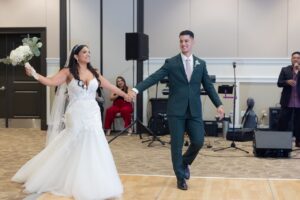 A bride and groom enter their wedding reception ballroom at Ocoee Lakeshore Center.