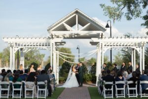 A bride and groom standing at the altar at the wedding garden outside at Ocoee Lakeshore Center.