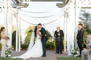A bride and groom share a first kiss as husband and wife at the Wedding Garden at Ocoee Lakeshore Center.