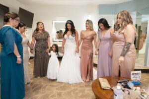 A bride and her bridal party and family say a prayer before the wedding inside a bridal suite at Ocoee Lakeshore Center.