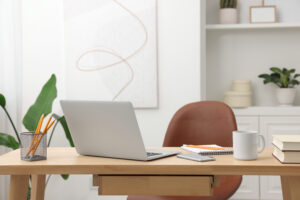 a in home office that is organized with a desk, computer, pencils in a neutral feel.