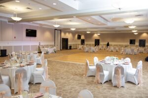 The banquet room inside Ocoee Lakeshore Center in Ocoee, FL where a wedding reception is taking place.