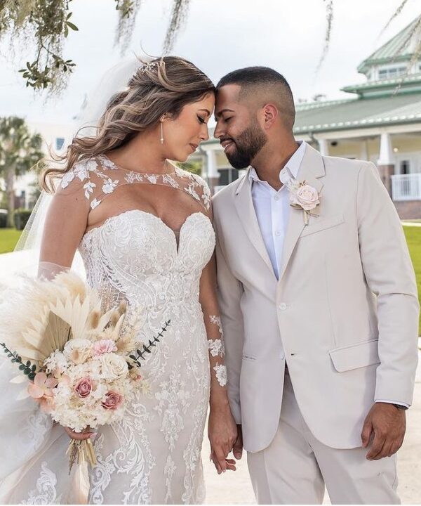 Bride and Groom in front of Ocoee Lakeshore Center in their summer fabric