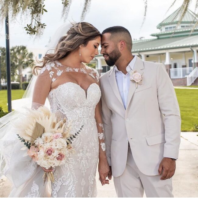 Bride and Groom in front of Ocoee Lakeshore Center in their summer fabric