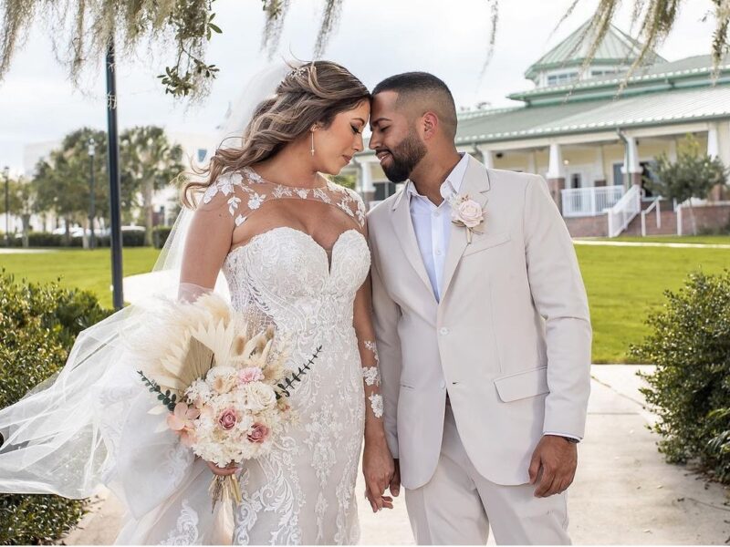 Bride and Groom in front of Ocoee Lakeshore Center in their summer fabric