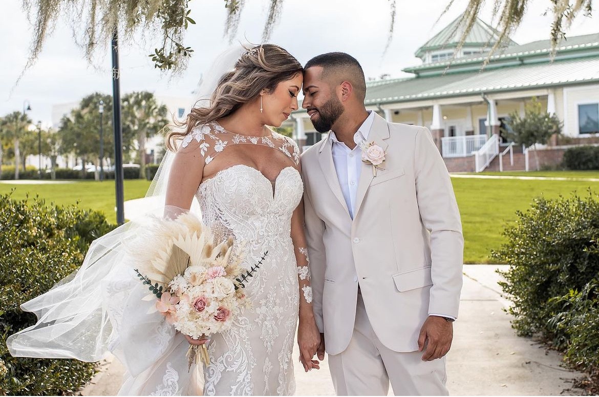 Bride and Groom in front of Ocoee Lakeshore Center in their summer fabric