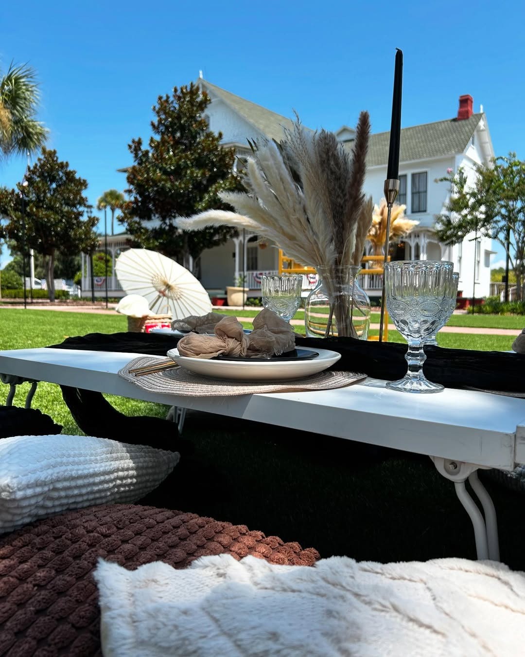 Picnic setup on lawn with Withers Maguire House in the background